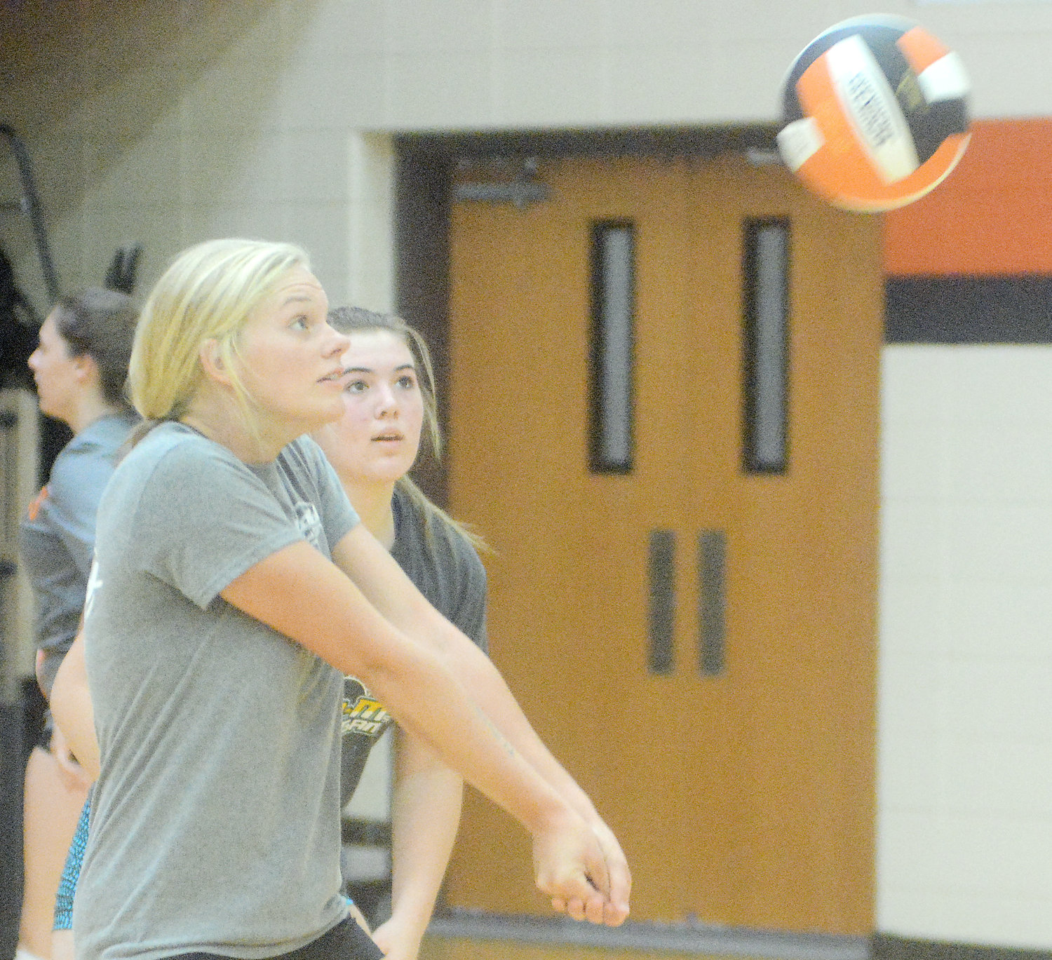 Josie Gerlemann (left) steps in front of teammate Maddie Lewis to bump the ball towards a setter during a recent Dutchgirl volleyball practice inside the Owensville High School main gym. Jaime Ridenhour’s Dutchgirl volleyball squad will compete in their preseason jamboree on Tuesday, Aug. 23 at Sullivan High School against the host Lady Eagles and Potosi Lady Trojans.